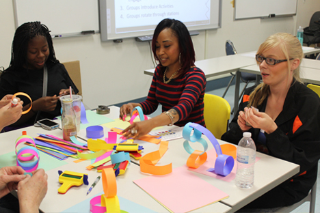Student instructors experiment with paper crafting materials.